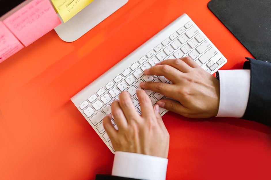 Hands typing at a keyboard while doing online data annotation work in India