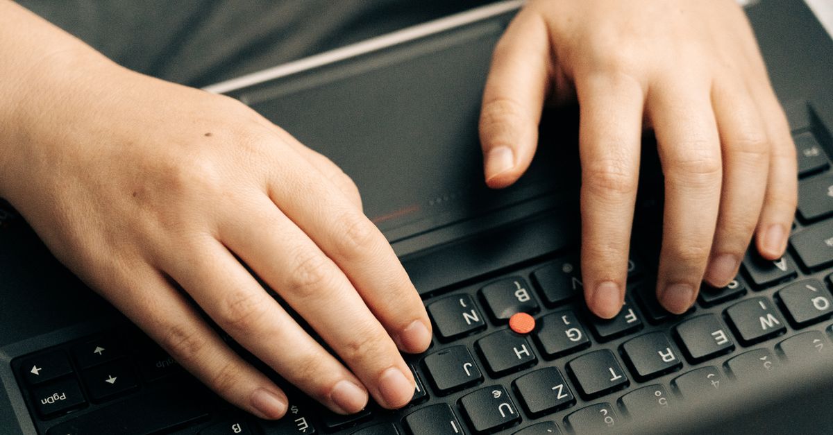 Hands typing on a keyboard while completing Appen annotation tasks