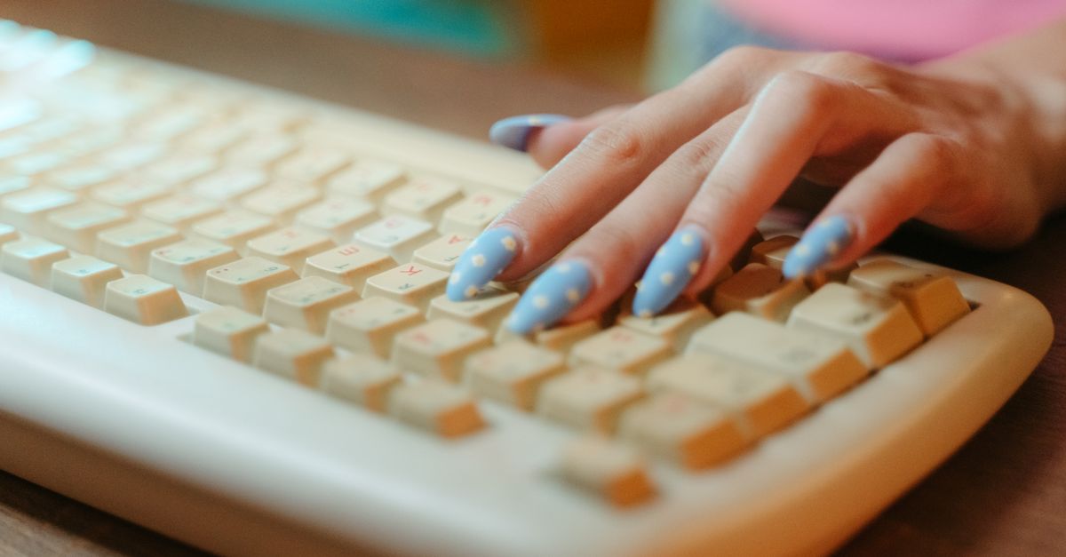 Hands typing on a keyboard while completing Clickworker and UHRS micro tasks