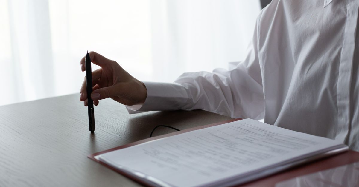 Hand with a pen over a foreign inward remittance advice document in India
