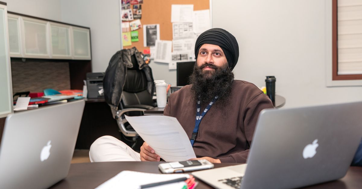 Indian man at a laptop writing Upwork proposals to land a first client