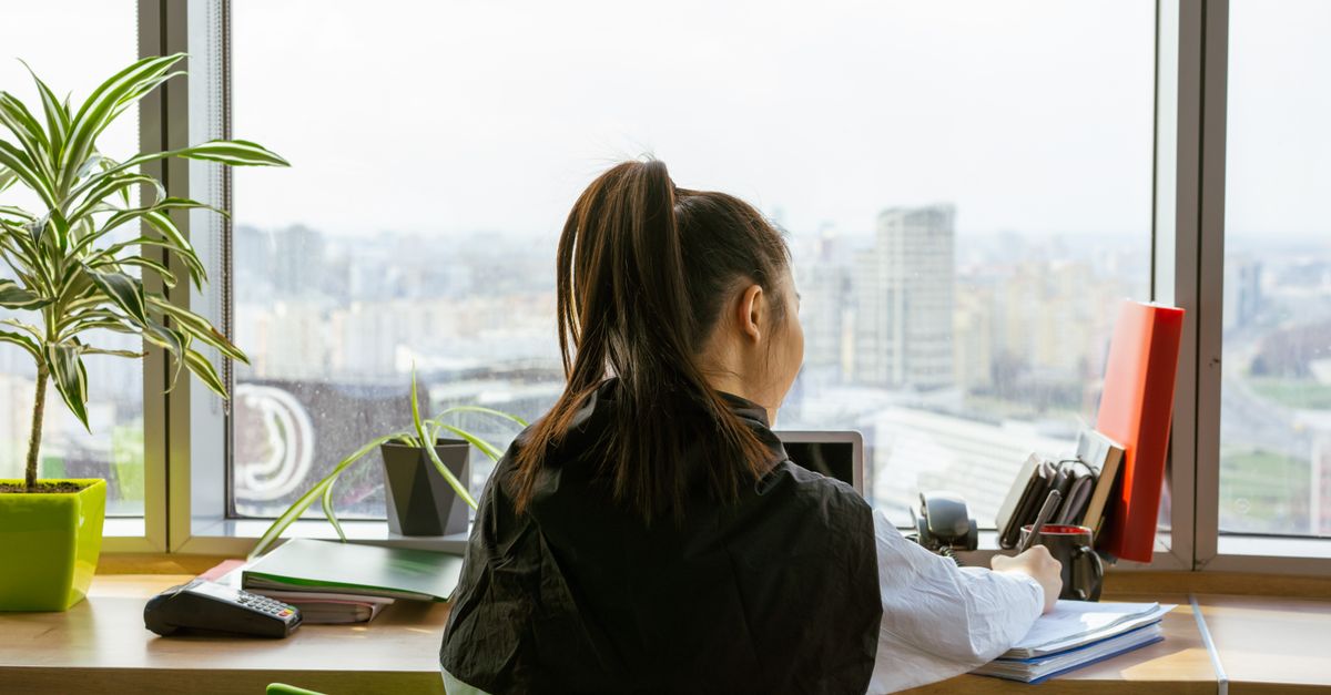 Indian woman at a desk reviewing foreign payments received into an Indian bank account