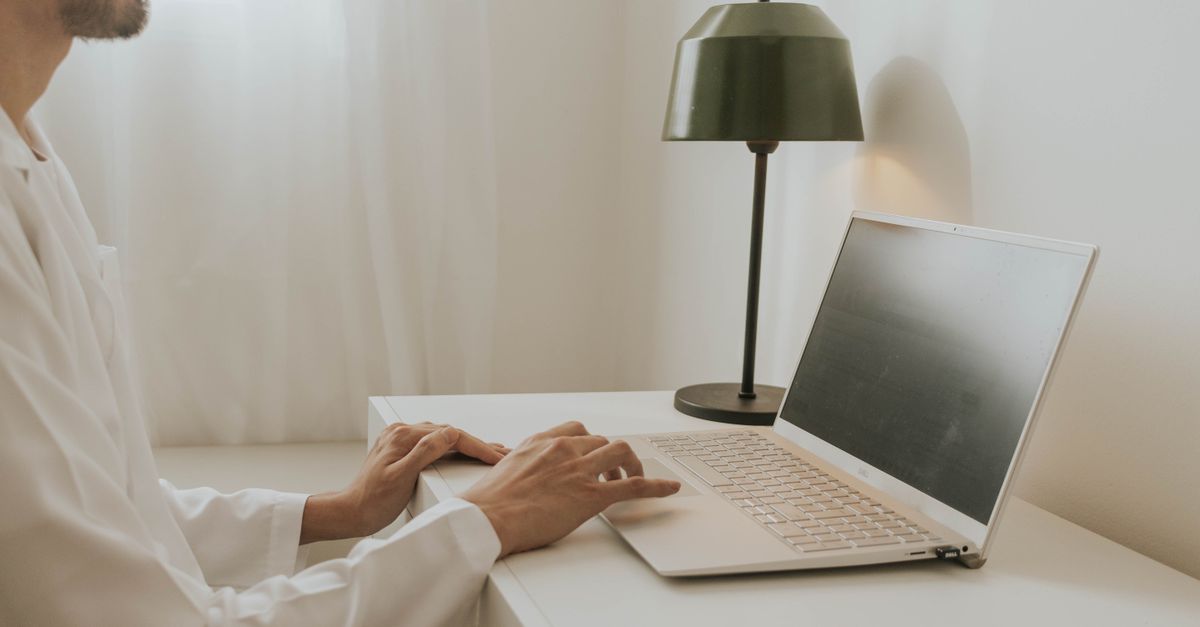 Laptop keyboard and notebook on a work desk