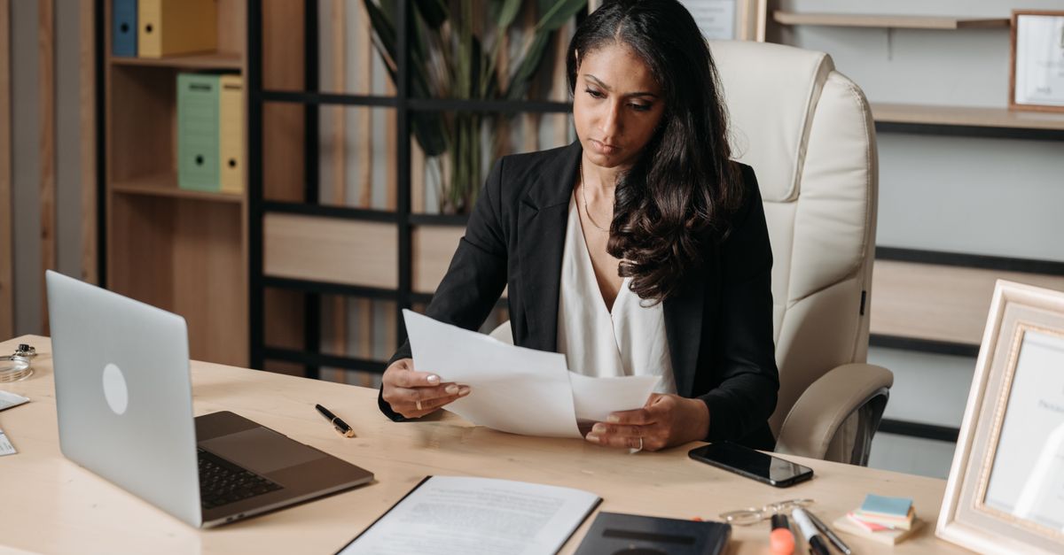 Indian woman reviewing documents to check whether she qualifies for Section 44ADA