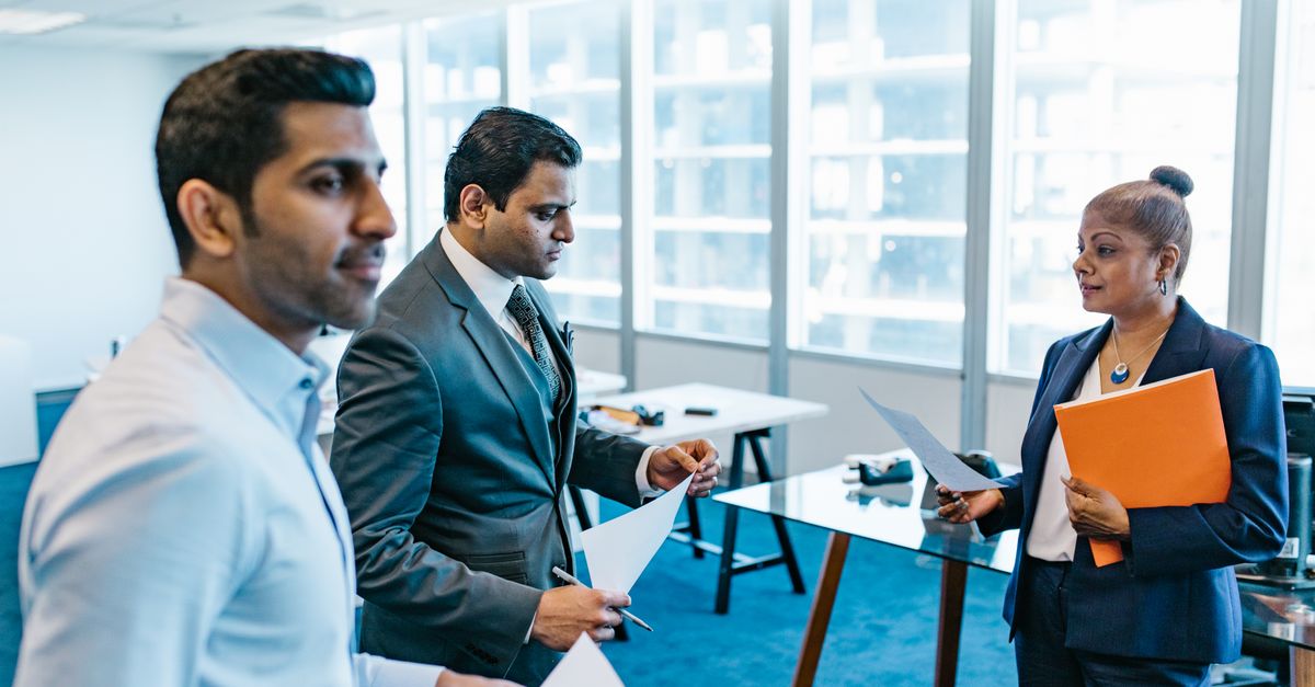 Indian professionals with documents, showing subject expertise that unlocks better paid queues