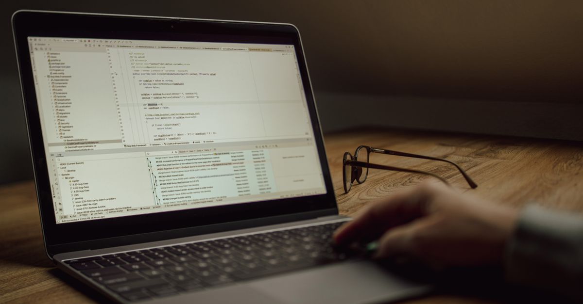 Laptop showing code, representing technical skills that command higher rates for Indians