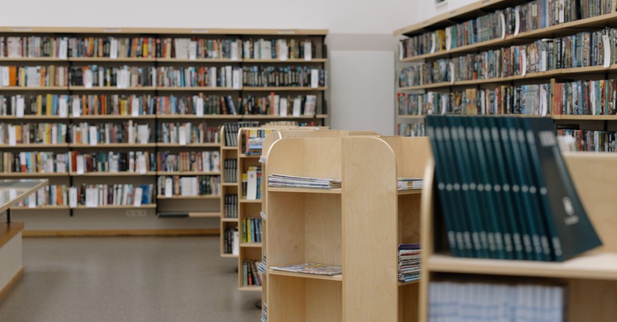 A university library with full bookshelves, a reminder that study time comes first