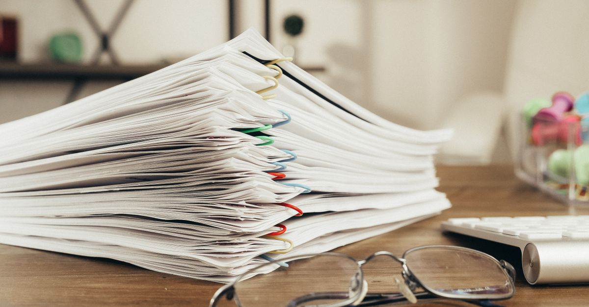 Thick stack of clipped paper on a desk, the size of batch these typing jobs assign