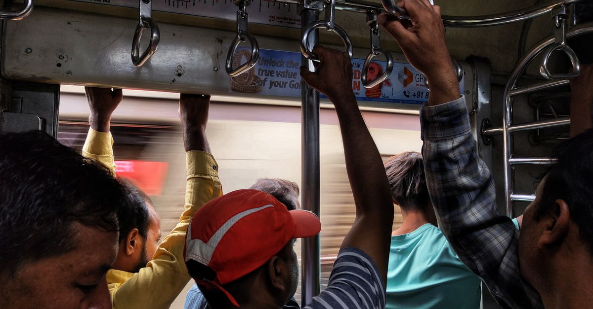 Passengers standing inside a busy Mumbai local train during a commute