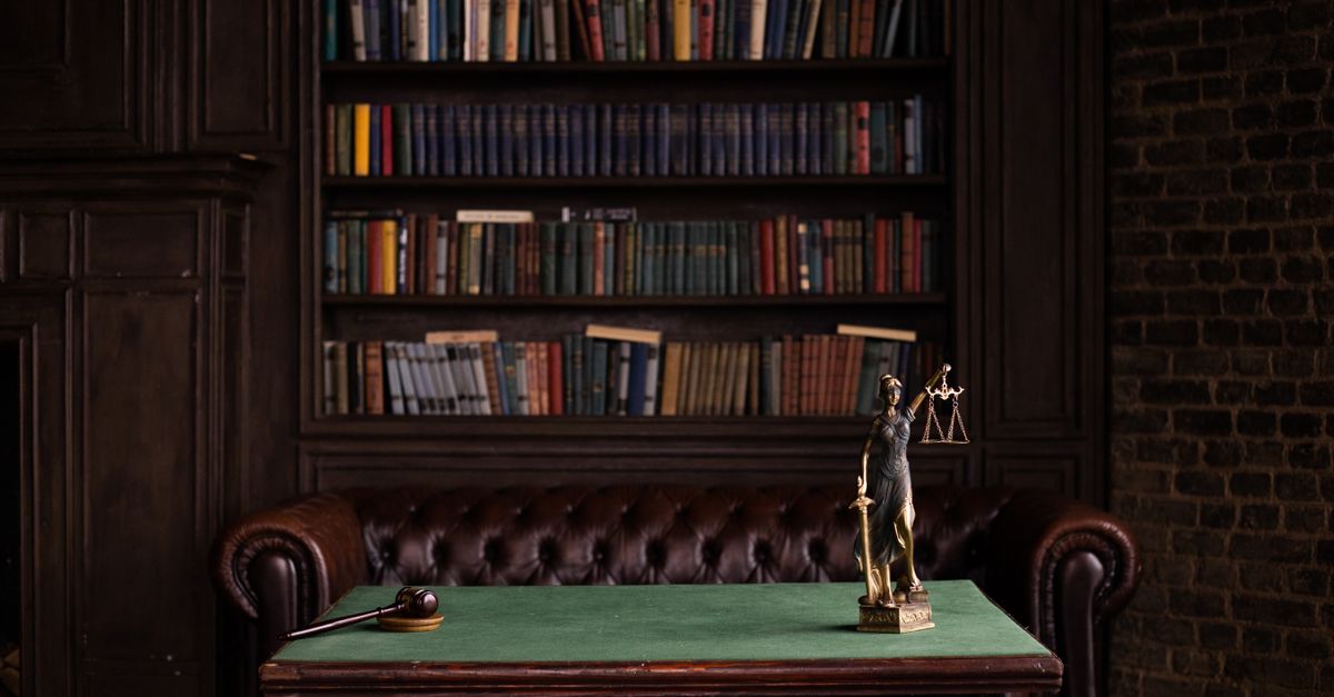 Law library desk with scales of justice, standing for the online gaming Act rules