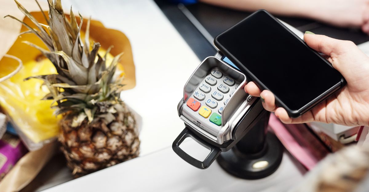 A phone tapped on a shop payment terminal, the everyday rail BRICS Summit 2026 talks about