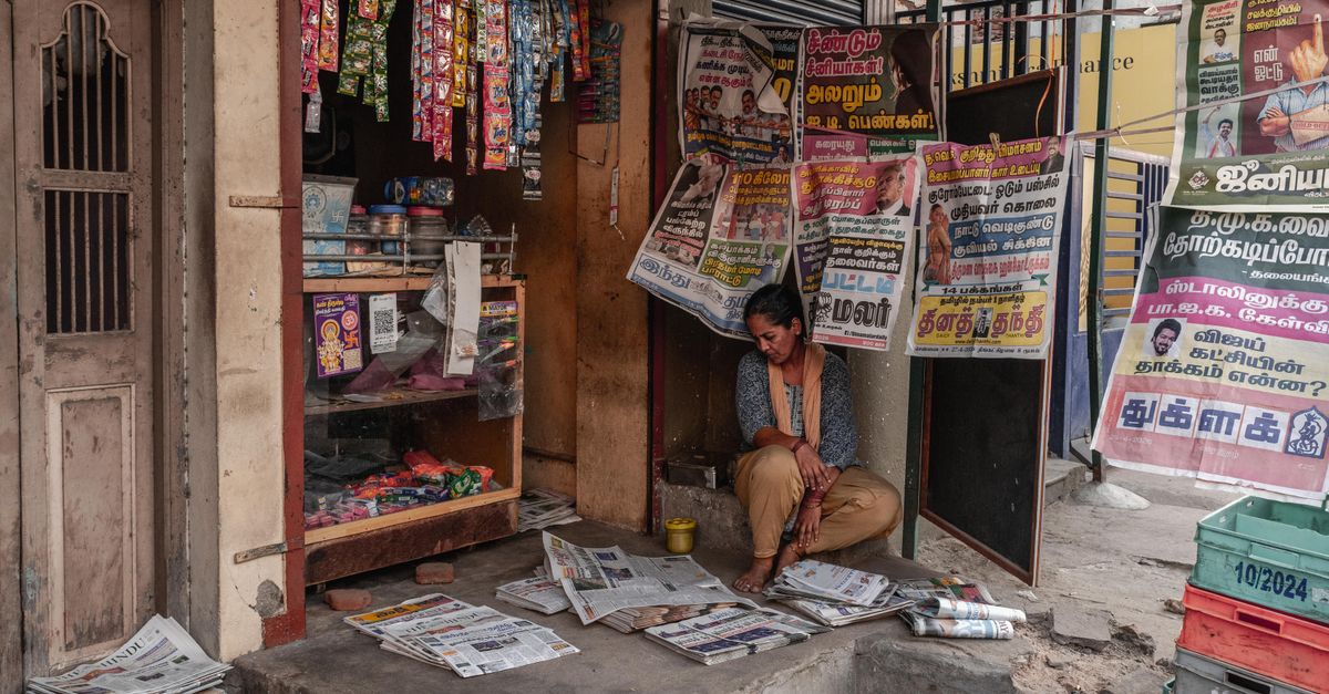 Indian newsstand stacked with regional language newspapers in several scripts